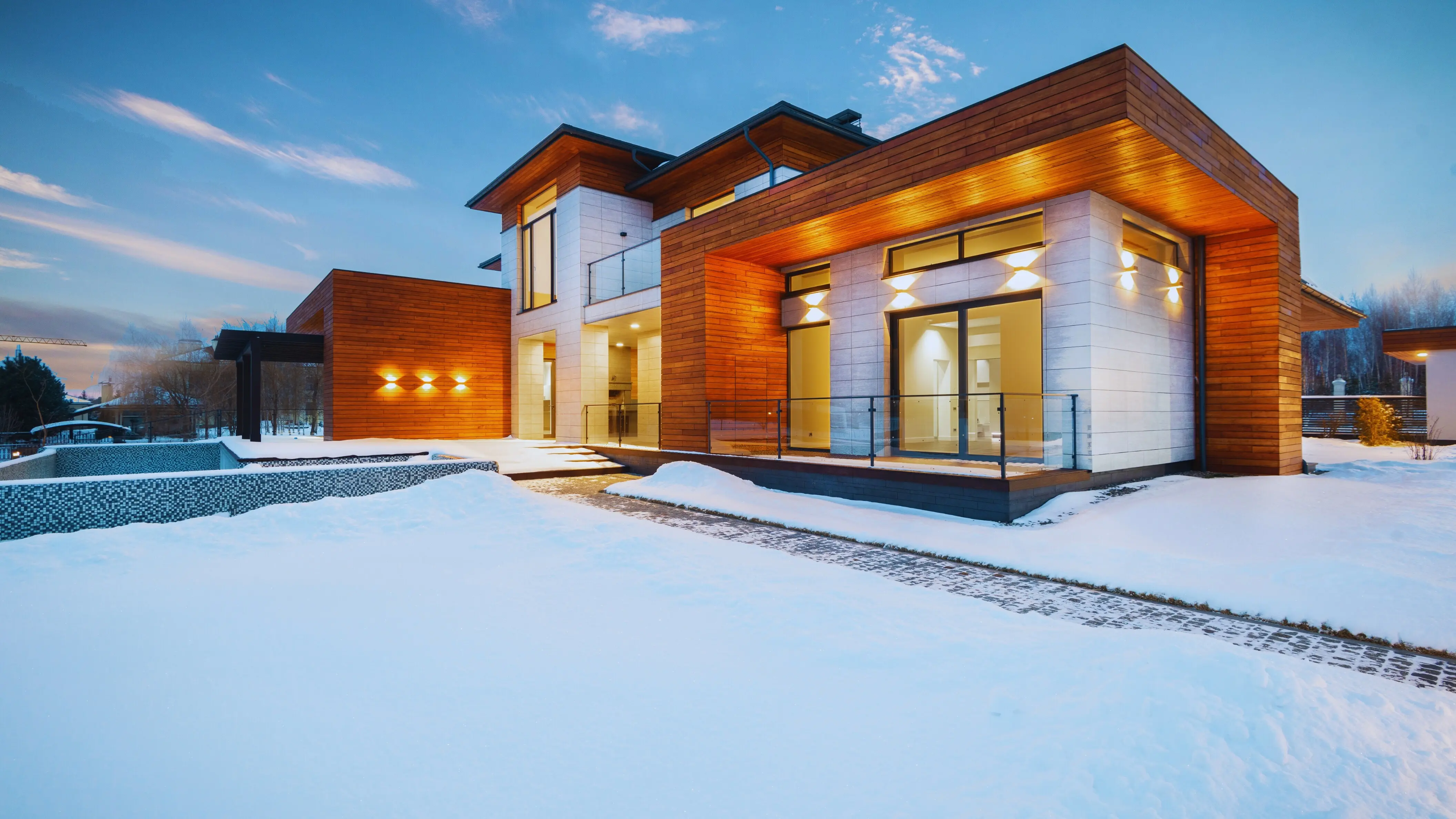 Elegant exterior of a luxury winter cottage in the snow.
